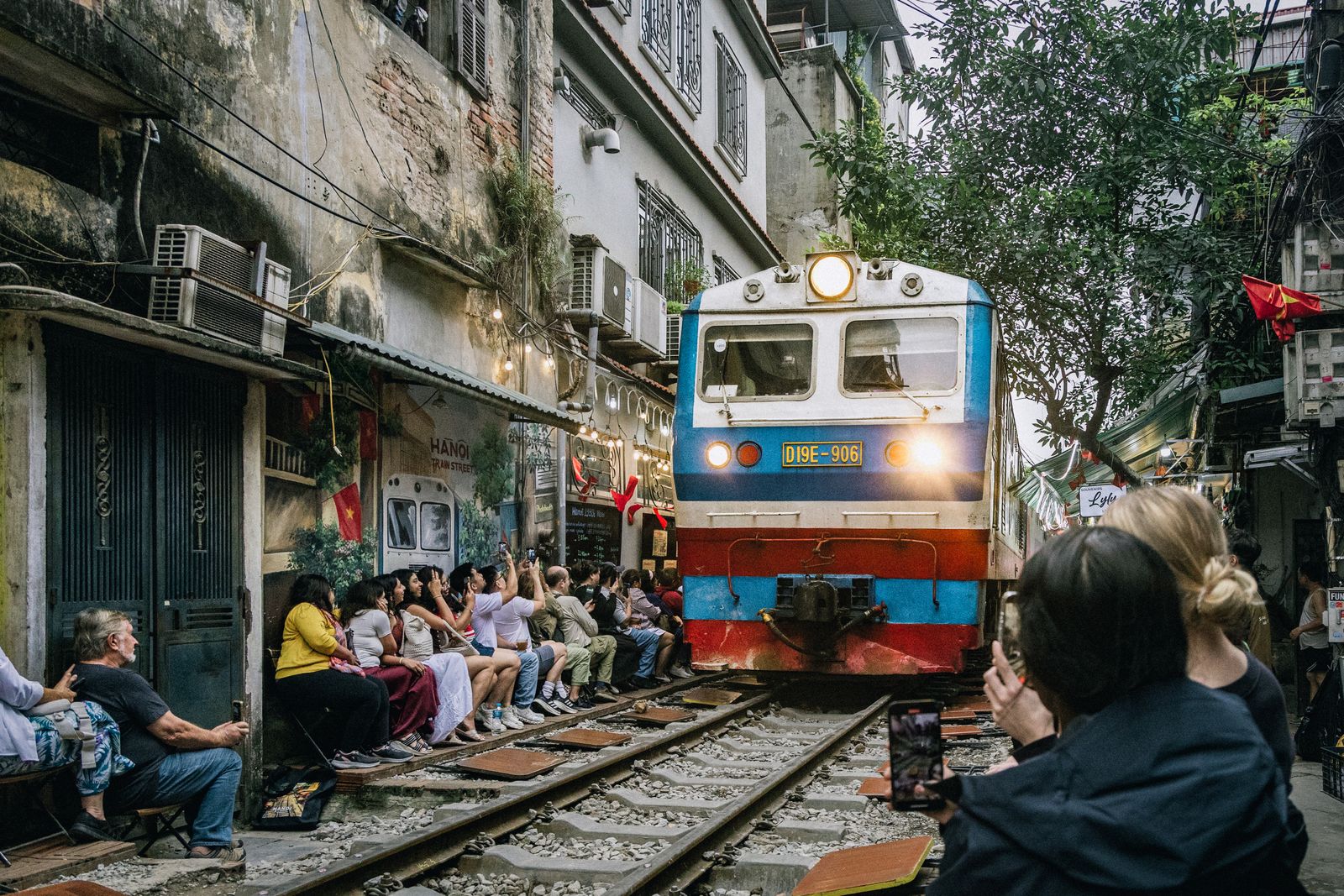 Image may contain Adult Person Urban Electronics Mobile Phone Phone People Railway Train and Transportation