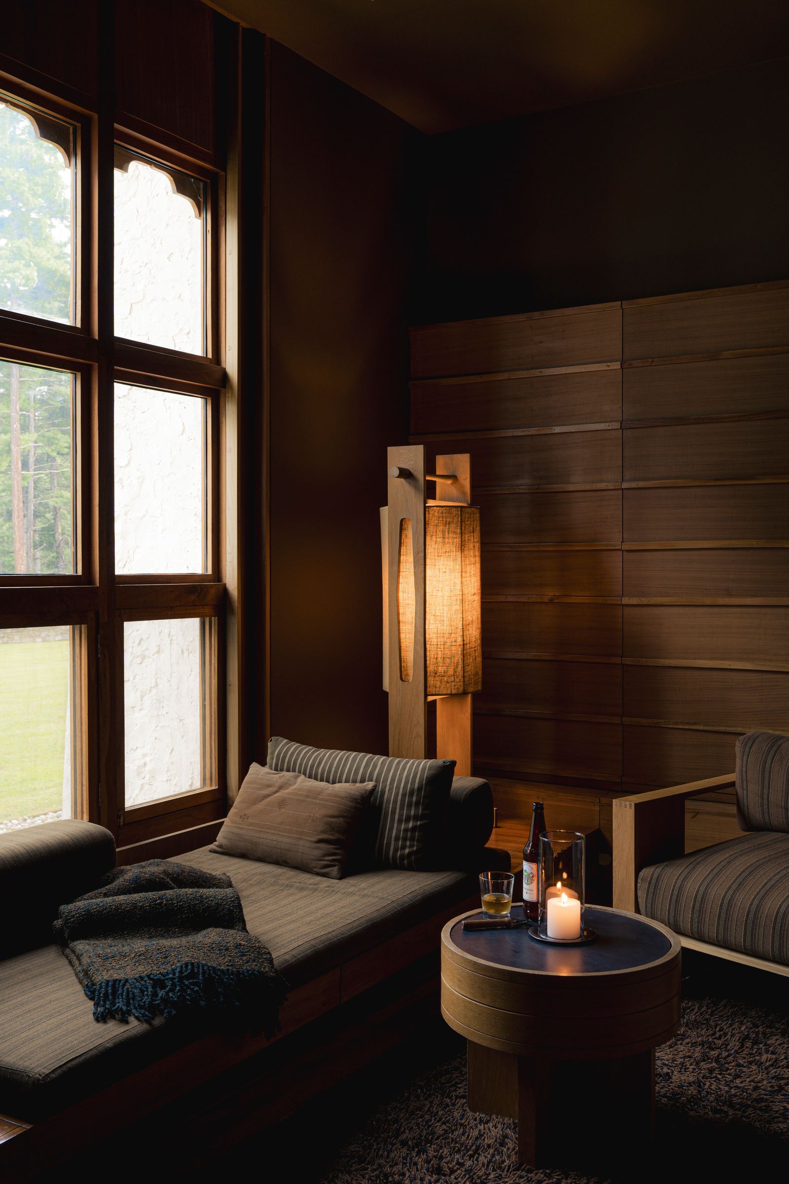 Image may contain Indoors Interior Design Wood Panels Couch Furniture Candle Architecture Building and Living Room