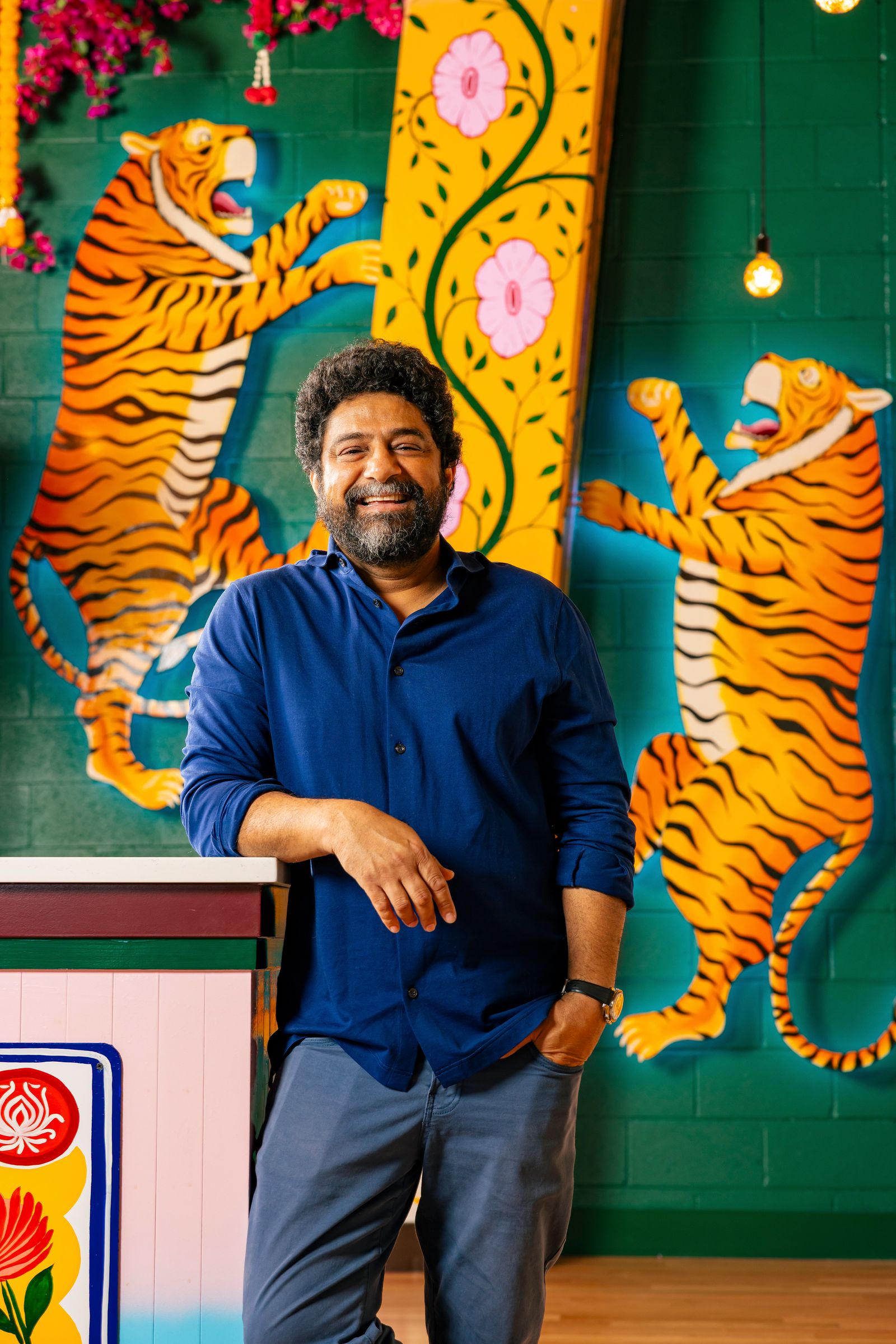 Image may contain Face Head Person Photography Portrait Happy Smile Adult Animal Mammal Tiger and Wildlife