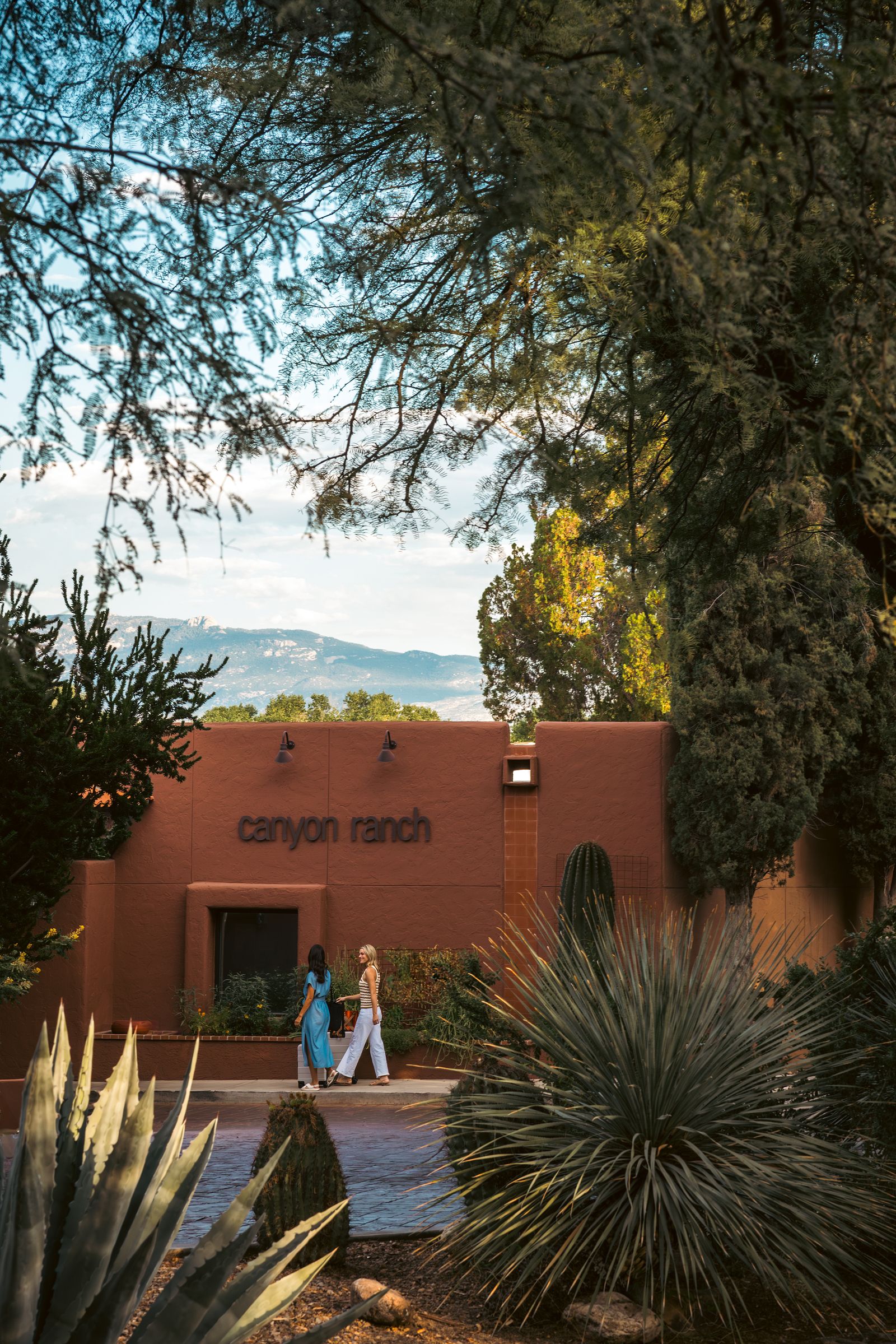 Image may contain Plant Vegetation Architecture Building House Housing Villa Tree Hotel Person and Walking