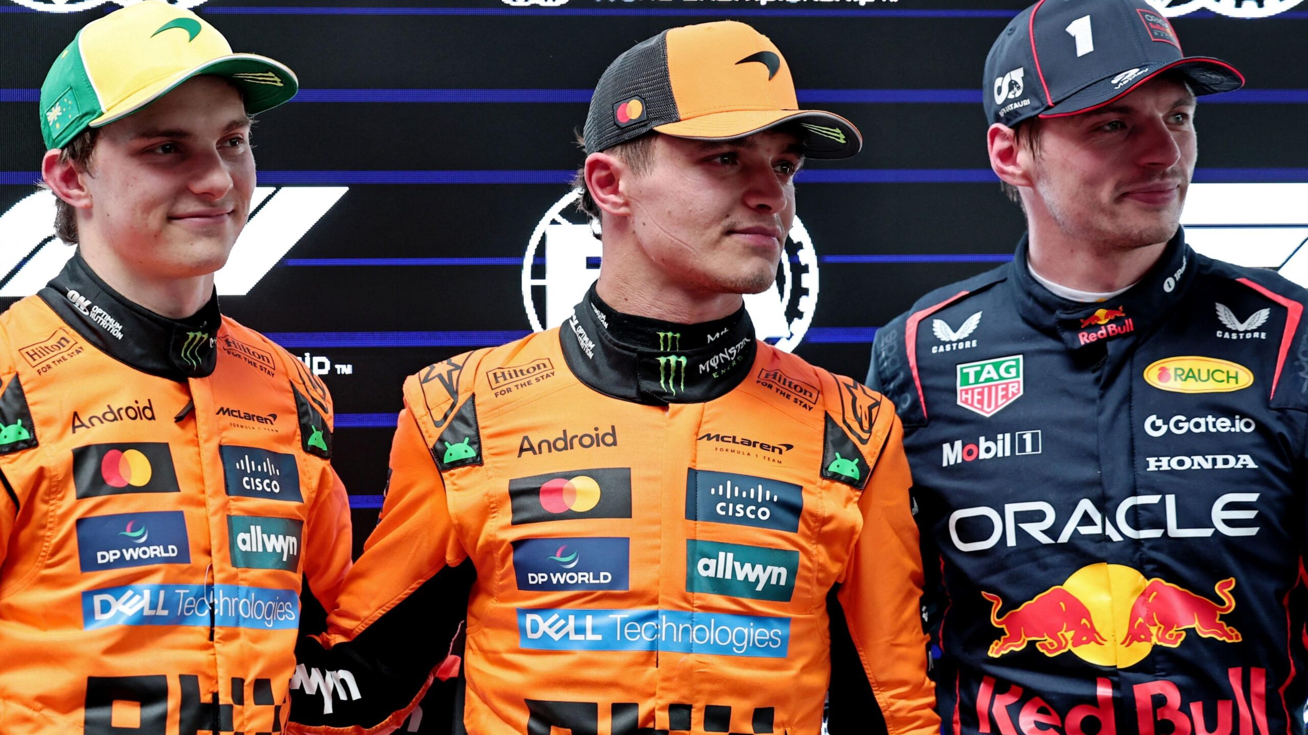 McLaren's Oscar Piastri, Lando Norris and Red Bull's Max Verstappen pose for pictures after qualifying for the 2025 Australian Grand Prix
