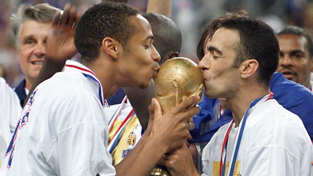 Thierry Henry kisses the World Cup trophy