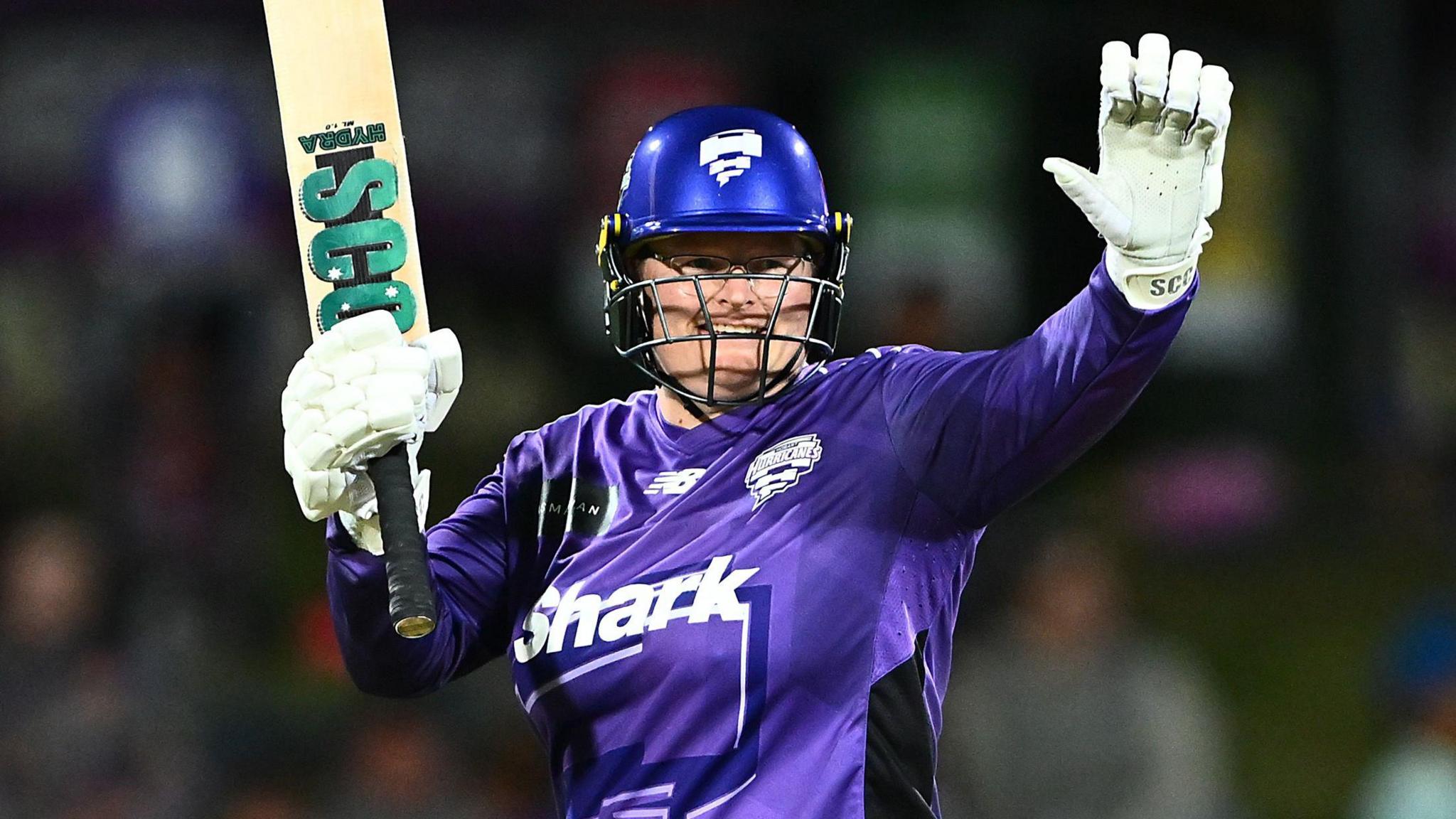 Hobart Hurricanes batter Lizelle Lee raises her bat after hitting fifty