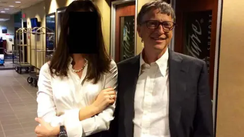 House Oversight Committee Bill Gates smiling and standing beside a woman whose face has been blacked out