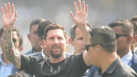 Getty Images Inter Miami's Argentine forward Messi raises his hands as he arrives at Salt Lake stadium in Kolkata.