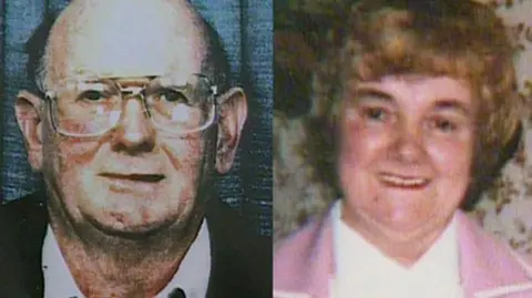 South Wales Police An composite of two photos. They are both grainy and appear quite old. On the left is an older man who is wearing glasses. On the right is a woman with short brownish hair. She is wearing a white top and a pink cardigan or jacket. She is smiling.