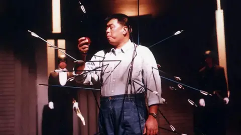 Jimmylai.substack.com Jimmy Lai bites an apple with a dozen of arrows into his body in a TV ad for the debut of Apple Daily in 1995