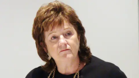 Dave Higgens/PA Wire Prof Alexis Jay during a press conference at the New York Stadium, Rotherham. She is wearing a dark top and has brown hair.