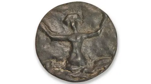 Bonhams A faded bronze button depicts a woman emerging from an ocean with her arms outstretched.