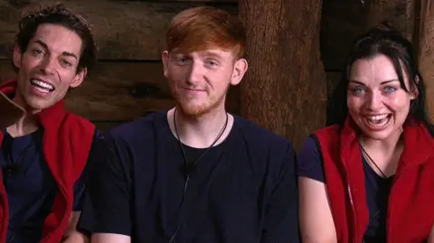 ITV/Shutterstock Tom, AngryGinge and Shona smile and giggle as they talk to the camera ahead of the final