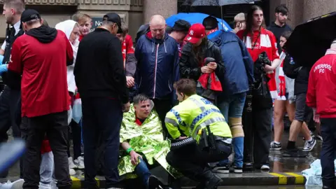PA Media Police and emergency personnel dealing with a road traffic accident on Water Street near the Liver Building in Liverpool after a car collided with pedestrians during the Premier League winners parade.