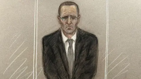 Julia Quenzler A court sketch of Paul Doyle, who is wearing a black suit with a grey tie and white shirt, in the dock. He has no expression on his face and is staring at the ground.
