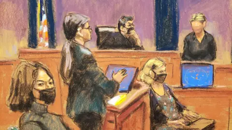 Reuters A court sketch of Kate testifying in Ghislaine Maxwell's trial. Kate is shown as wearing a black shirt and having fair hair but her face is blurred in the sketch to protect her identity. She stands in the witness box with a judge wearing a black Covid-era face mask to the left of her. In front of her is the stenographer and one of the attorneys, a woman with a long brown ponytail. Ghislaine Maxwell is pictured in the foreground, frowning under her own black face mask, and looking away from the witness.