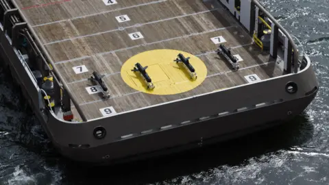 Helsing An aerial shot of ship carrying four gliders lined up in a row on the deck.