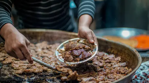 Maroof Culmen A man serves kebabs in Lucknow