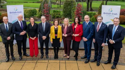 Welsh Government/PA Wire Chief Minister of Jersey Lyndon Farnham, First Minister of Scotland John Swinney, Government of Guernsey Deputy Lindsay de Sausmarez, Prime Minister Sir Keir Starmer, First Minister of Wales Eluned Morgan, First Minister of Northern Ireland Michelle O'Neill, Deputy First Minister of Northern Ireland Emma Little-Pengelly, Taoiseach Micheal Martin, Tanaiste Simon Harris and Chief Minister of the Isle of Man Alfred Cannan during the British-Irish Council (BIC) meeting at The Vale in Cardiff.