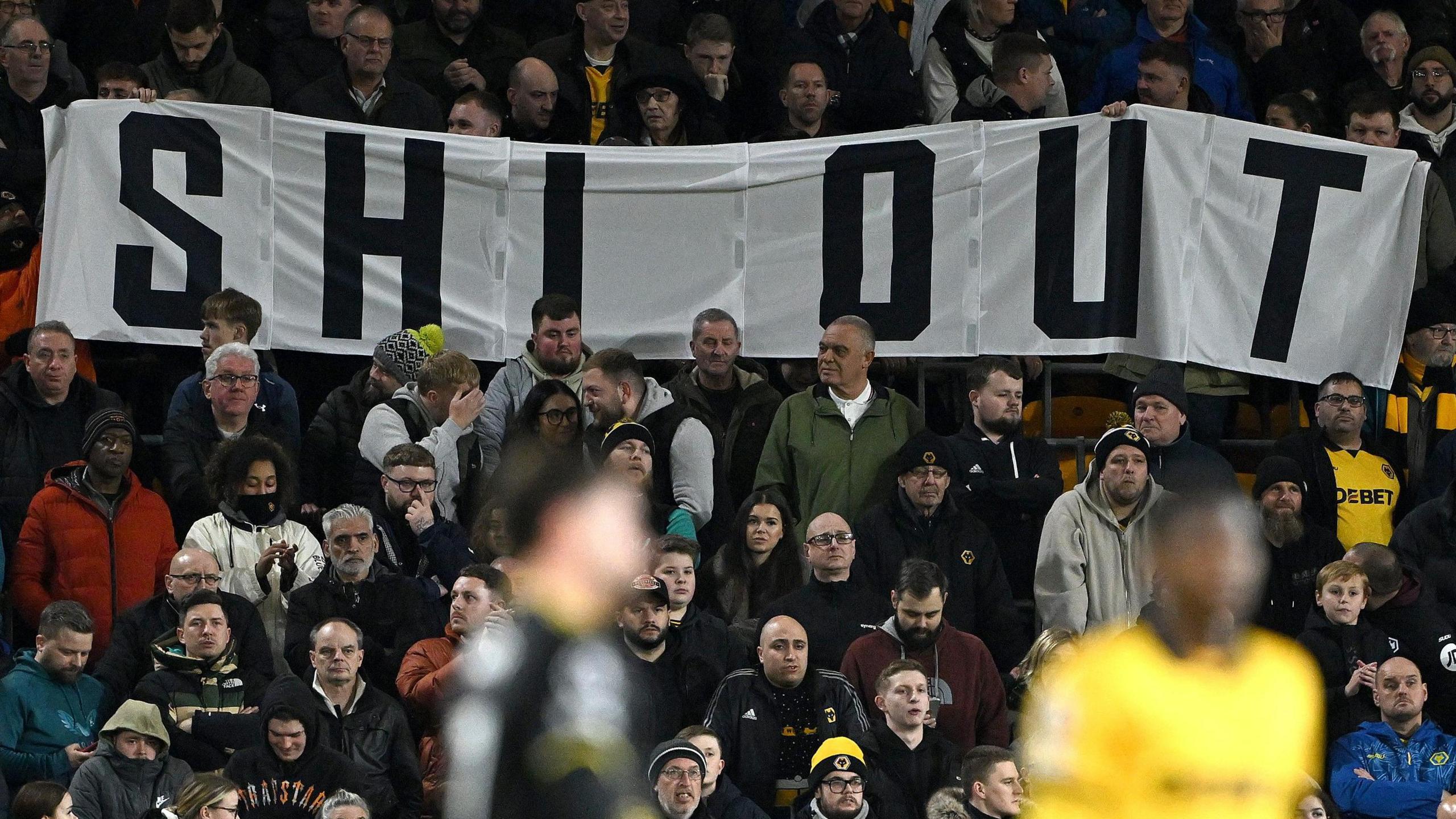 Wolves fans hold a Shi Out banner