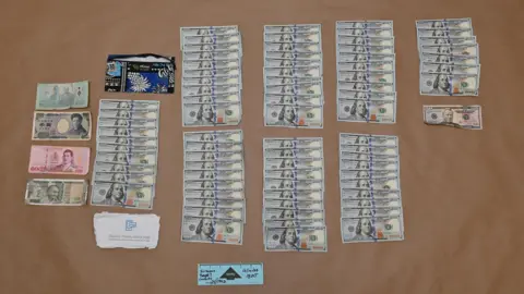 New York County District Attorney's Office Dozens of $100 bills found during Mr Mangione's arrest