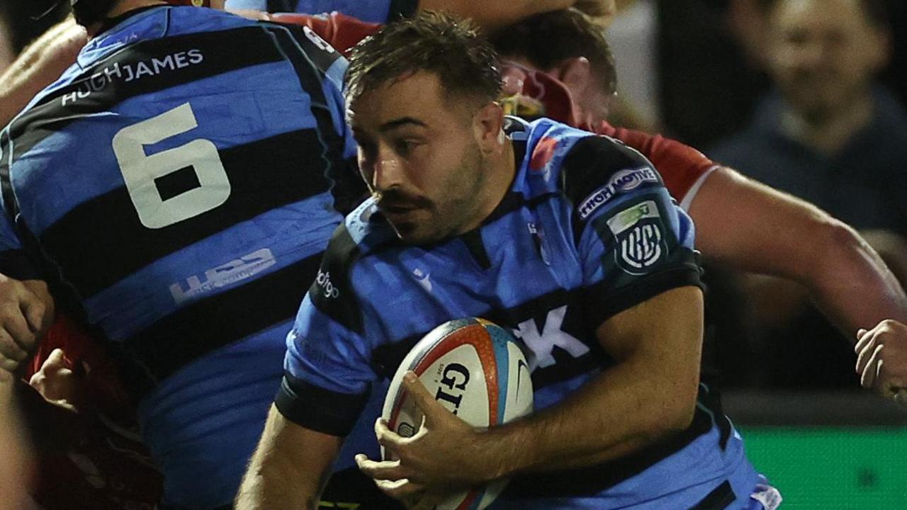 Cardiff captain Liam Belcher carries the ball in his left hand