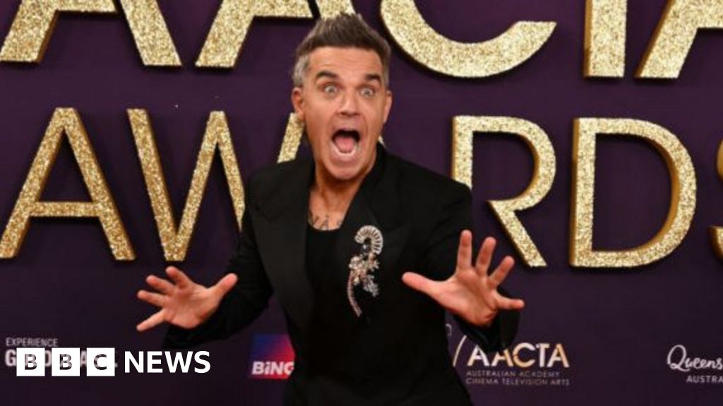 Watch moment Robbie Williams surprises 94-year-old fan