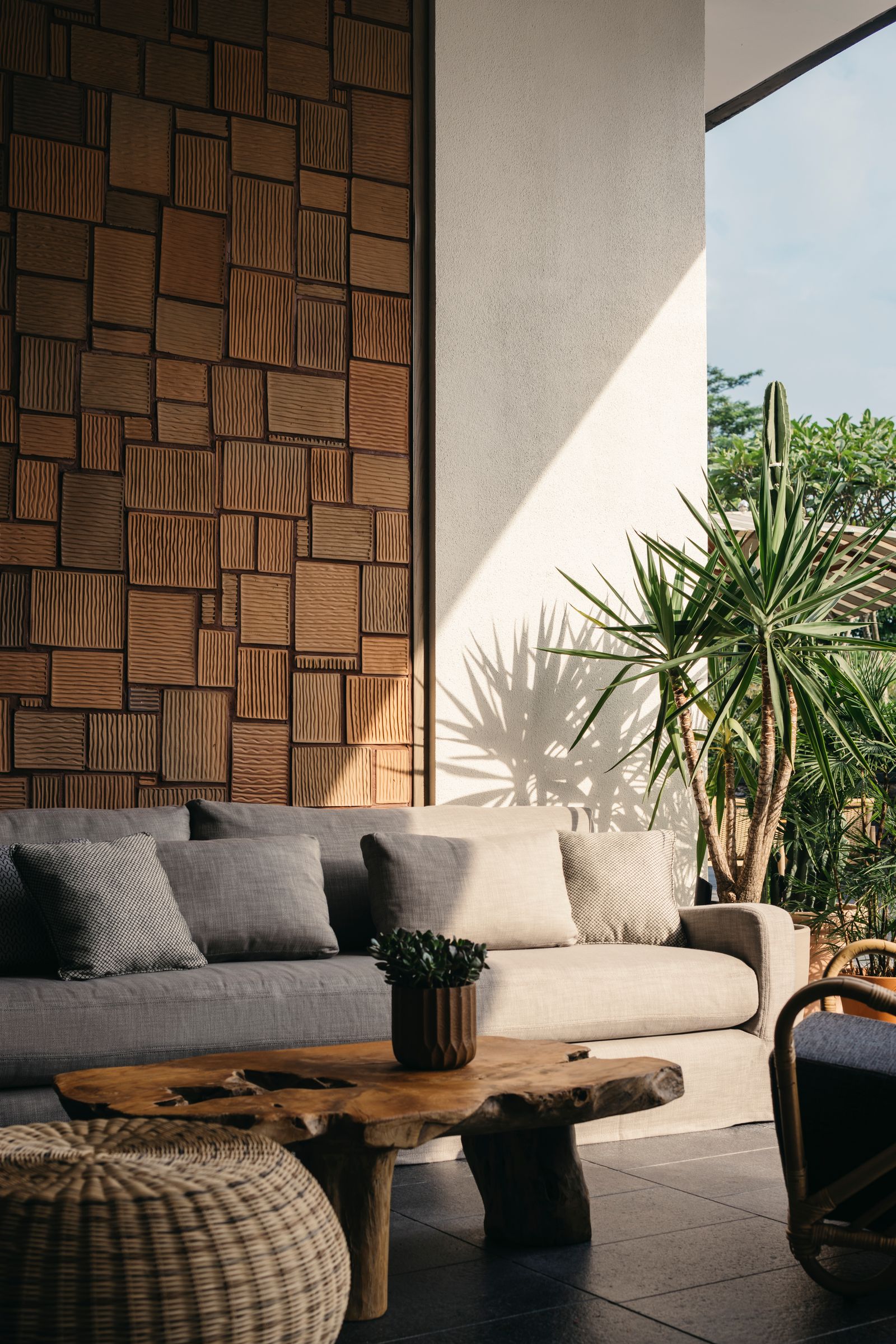 Image may contain Indoors Interior Design Wood Panels Plant Couch Furniture Home Decor and Chair