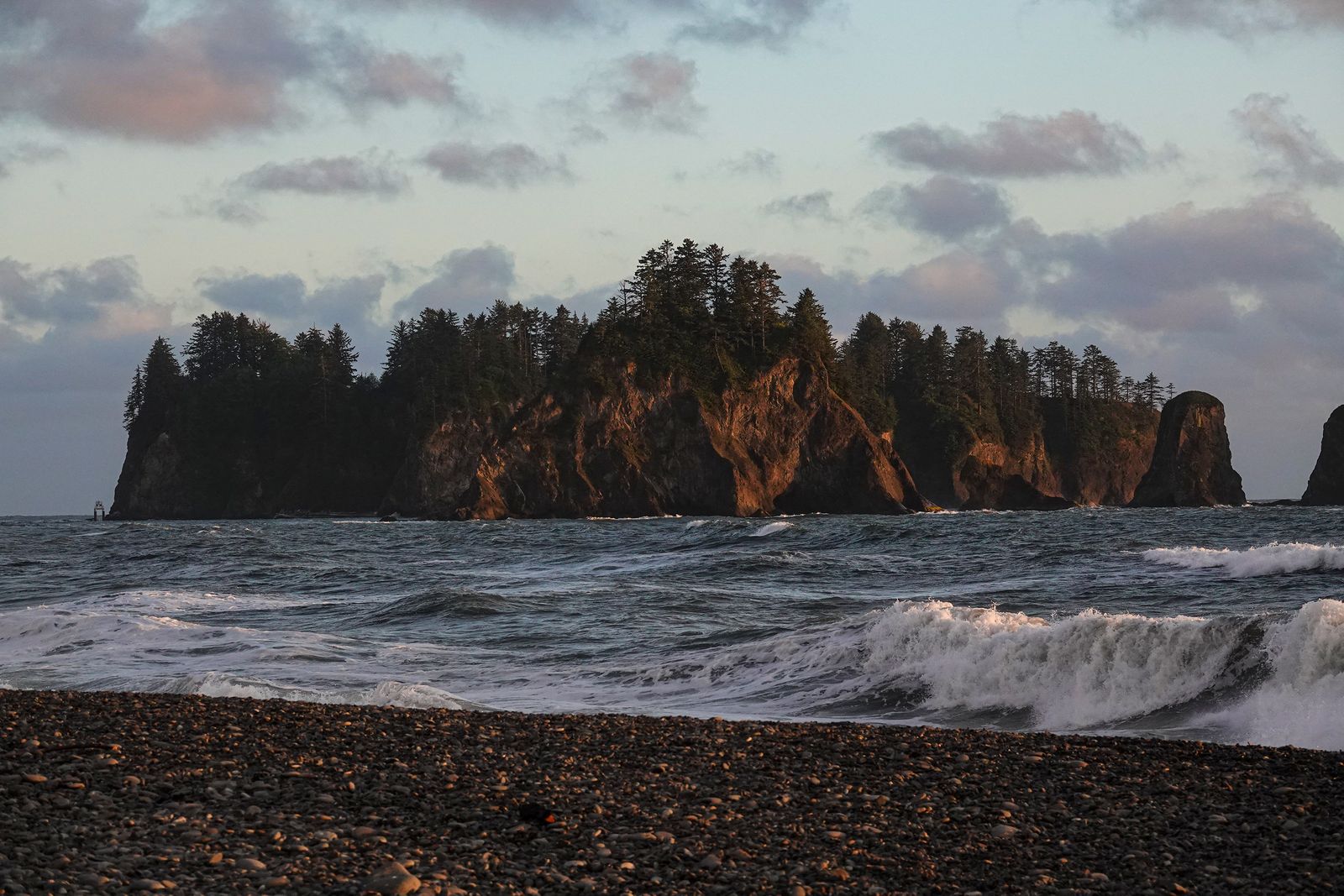 Image may contain Rock Nature Outdoors Sea Water Beach Coast Shoreline Scenery Plant Vegetation Land and Sky