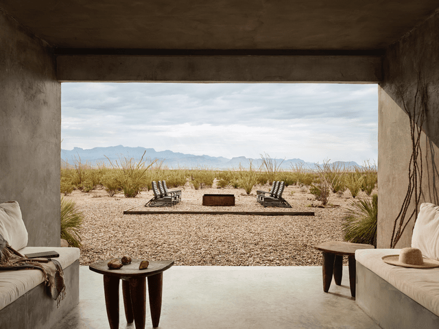 Room open to the outdoors looking at dirt and mountains
