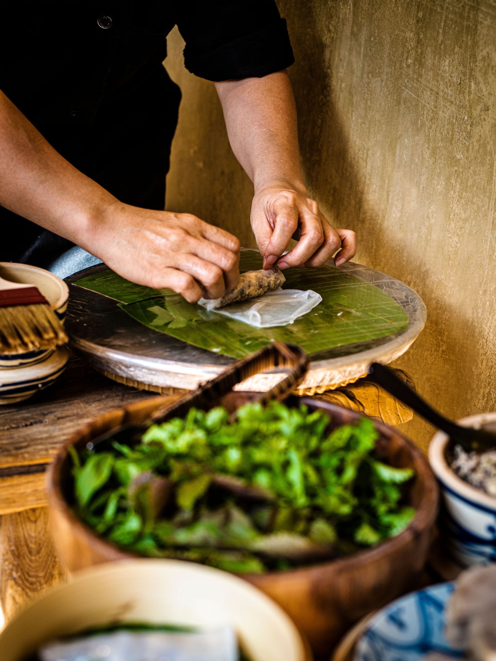 Image may contain Blade Weapon Knife Chopping Board Food Adult Person Chopping Ingredients Cooking Child and Plant