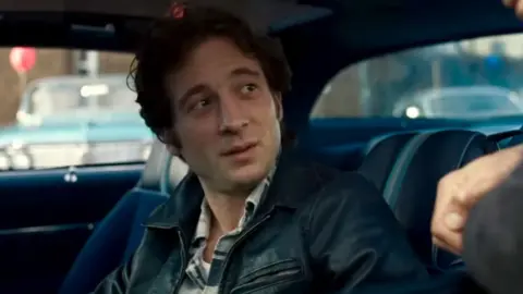 20th Century Studios Jeremy Allen White as Bruce Springsteen, sitting in a car