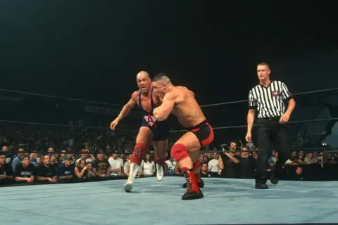 WWE via Getty Images  John Cena in action against Kurt Angle during SmackDown at Allstate Arena on June 25, 2002 in Rosemont, Illinois.