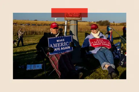 AFP via Getty Images Supporters hold signs during a Make America Great Again campaign rally