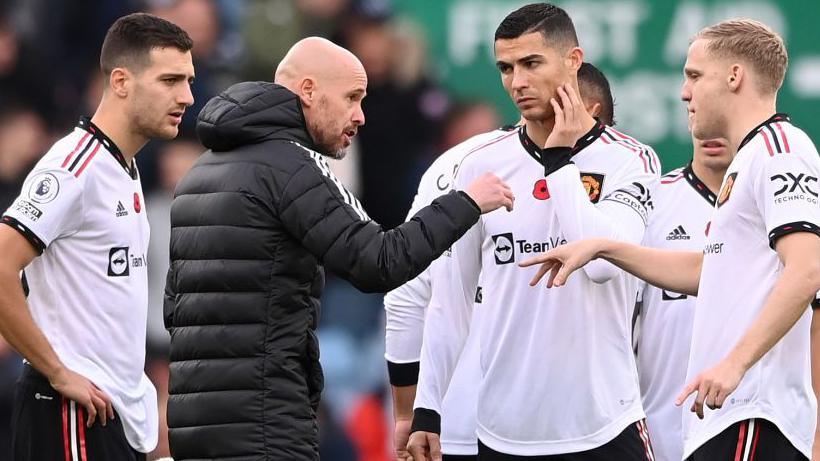 Cristiano Ronaldo of Manchester United listens as manager Erik ten Hag gives instructions