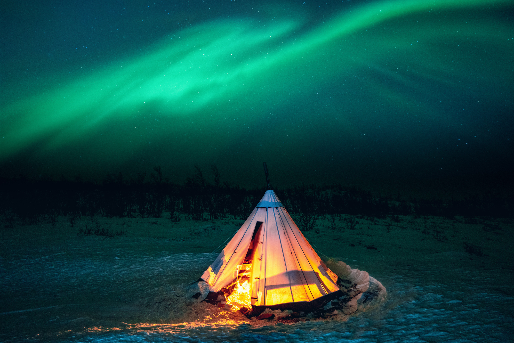 Aurora Borealis on a tent in the snow, Swedish Lapland