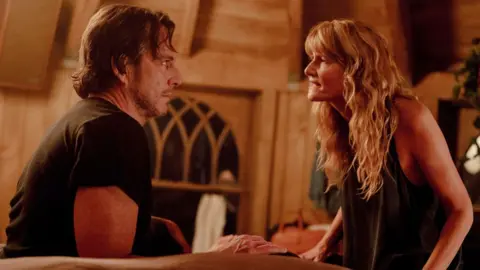 Searchlight Will Arnett and LAura Dern, facing each other, in Is This Thing On?