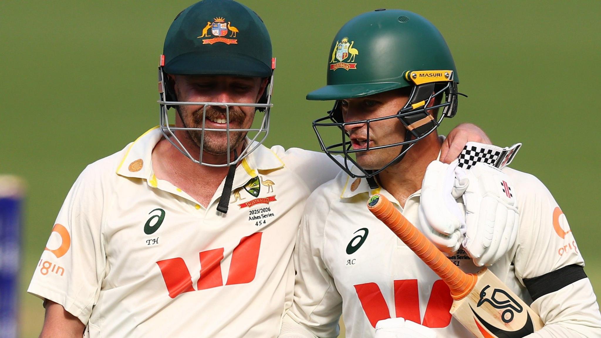 Travis Head and Alex Carey embrace
