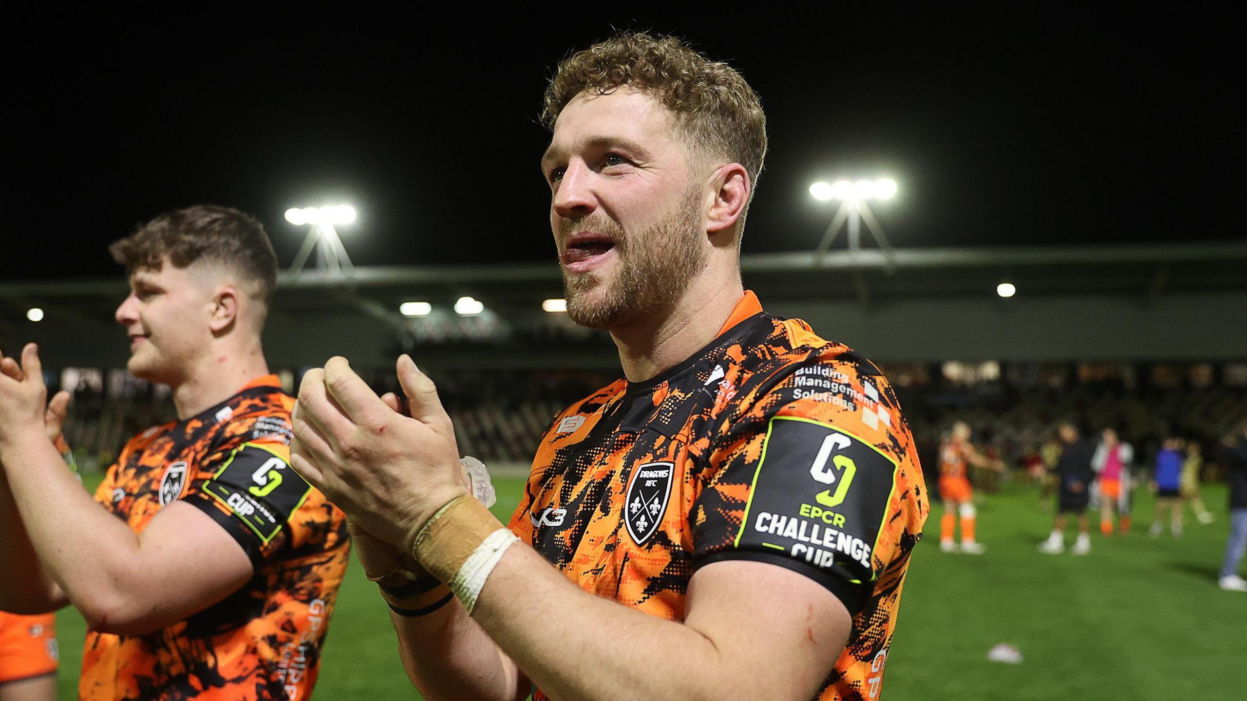 Angus O'Brien applauds supporters after Dragons beat Lyon in the Challenge Cup