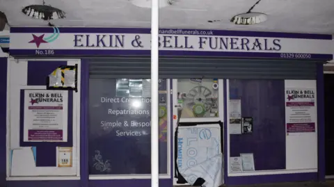 CPS The front of Elkin and Bell Funerals, with purple logos and lettering