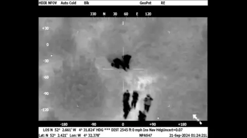 Dyfed-Powys Police Police helicopter footage of two men Geraint Berry, 46, from Swansea, and Steven Thomas, 47, from Blaengwynfi, Neath Port Talbot. Who were hiding in undergrowth near a caravan site in Cenarth, Wales.