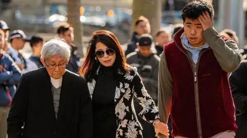 Getty Images Teresa Lai (C) and Lai Shun-yan (R), the respective wife and son of pro-democracy media tycoon Jimmy Lai, and Cardinal Joseph Zen (L), the former bishop of Hong Kong, arrive at the West Kowloon Law Courts