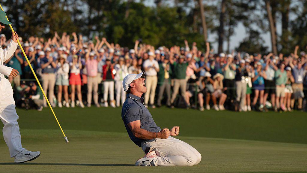 Rory McIlroy falls to the floor after winning a sudden death play-off round to win the Masters
