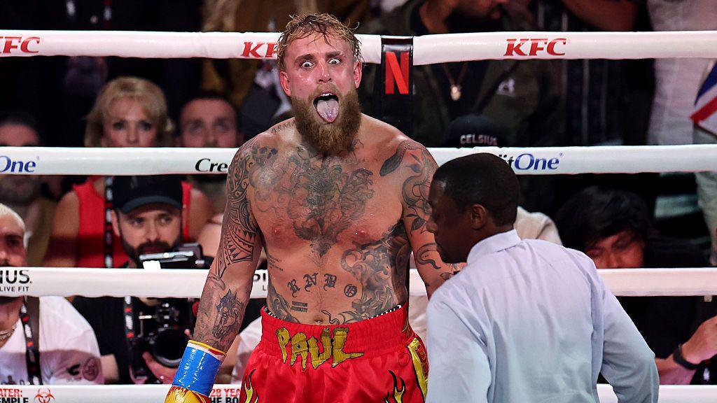Jake Paul sticks his tongue out in the ring
