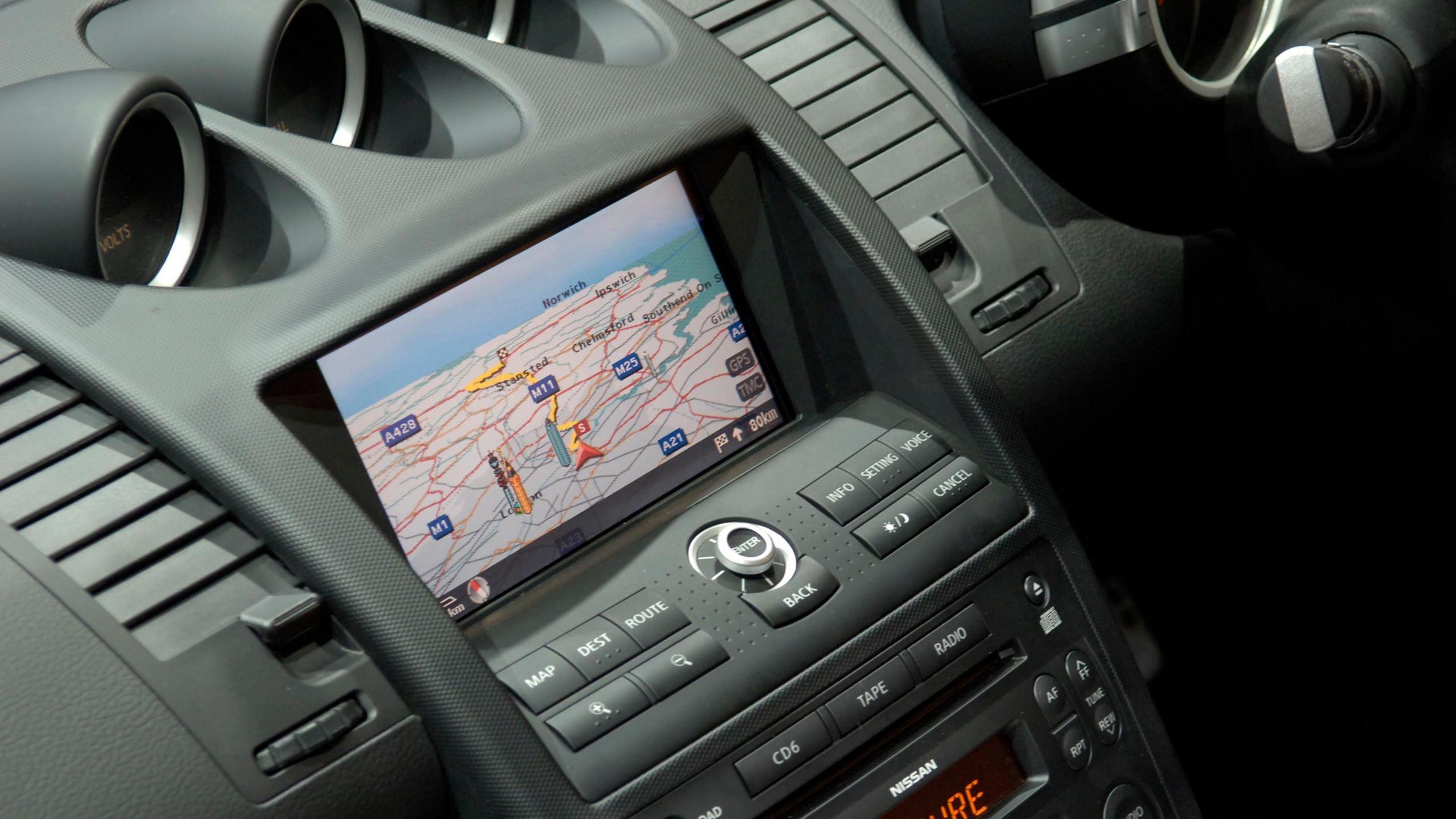 A photo of a car's interior with a sat-nav map displayed on the central console