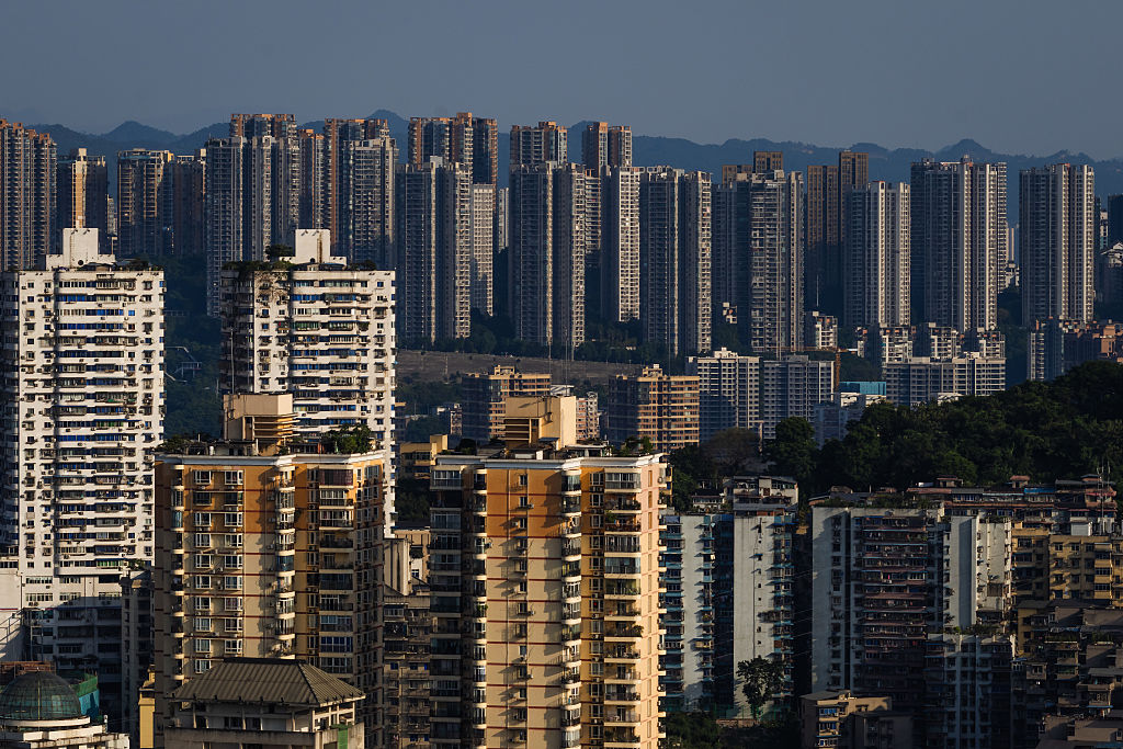 Dense clusters of residential high-rises dominate the skyline in a suburban area of Chongqing, reflecting the city&#039;s rapid urbanization and population growth